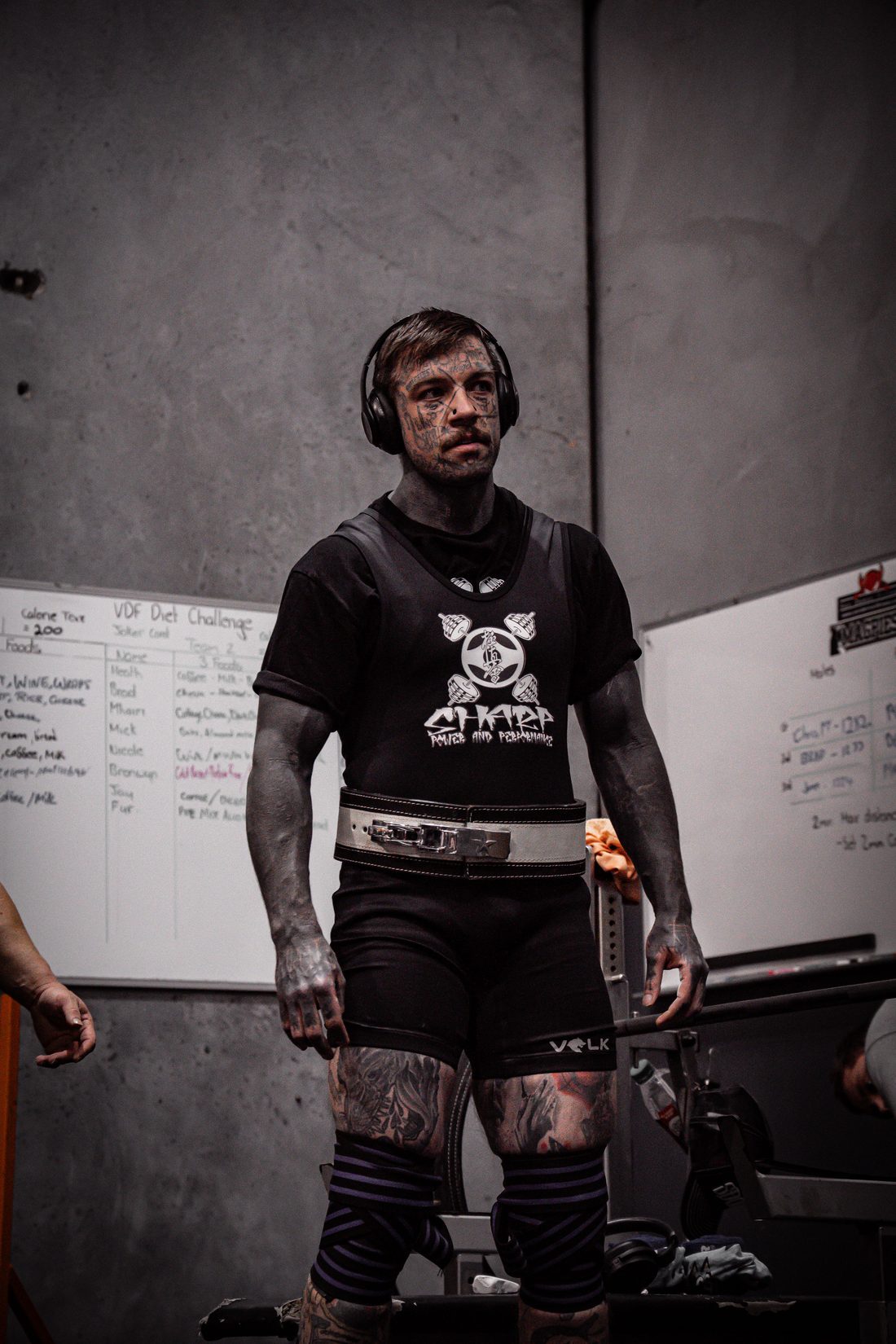 Tim standing between attempts, belt on, headphones in