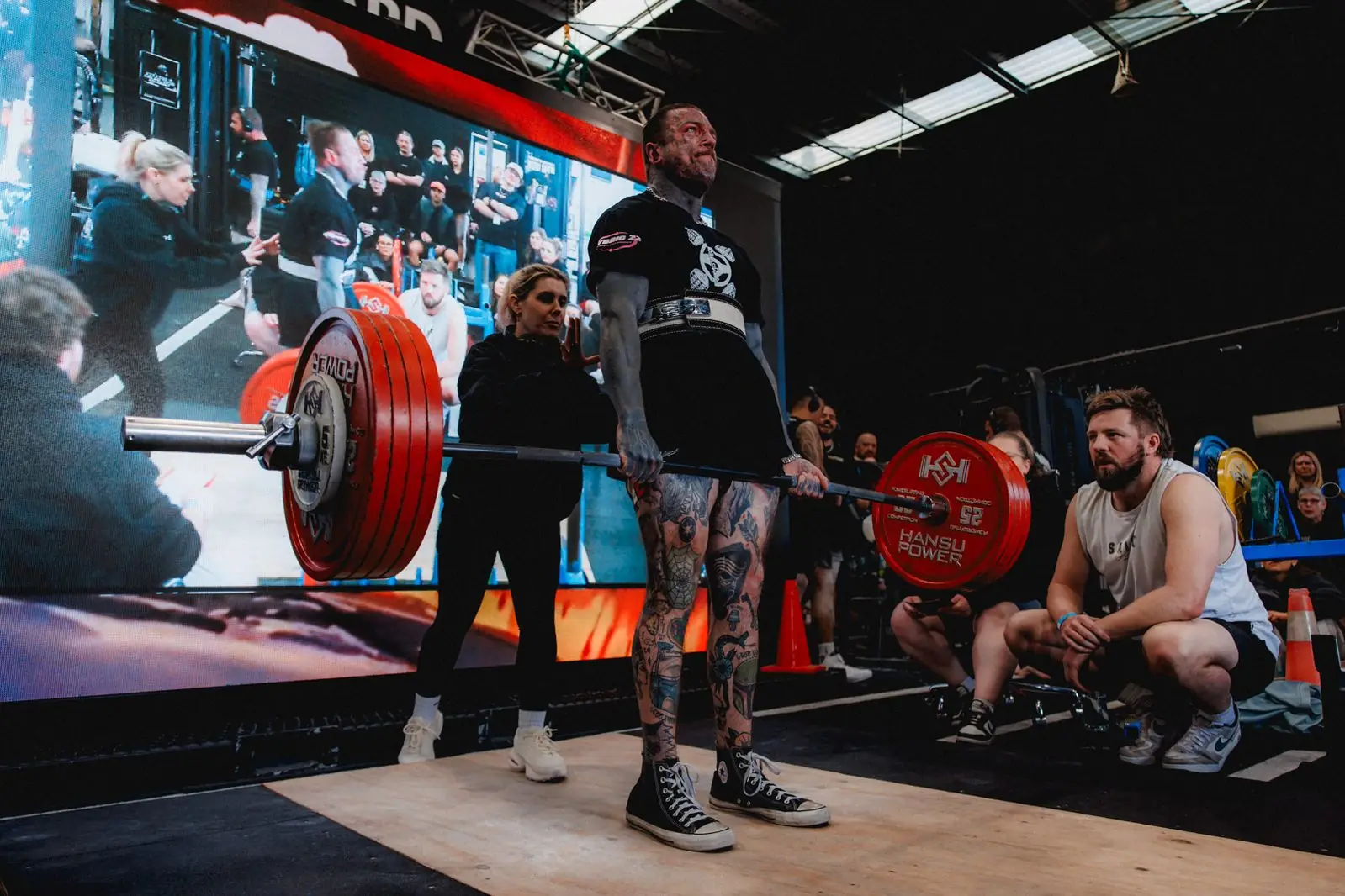 Tim Sharp locking out a deadlift on the competition platform